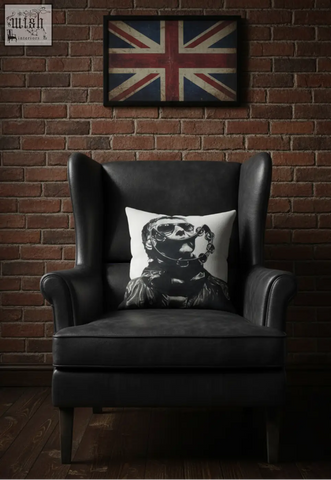 Black leather wingback armchair with liam cushion featuring a white pillow with a skull in diving gear graphic