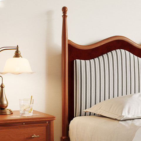 Wooden liam super king size bed with a curved headboard upholstered in black and white vertical striped fabric