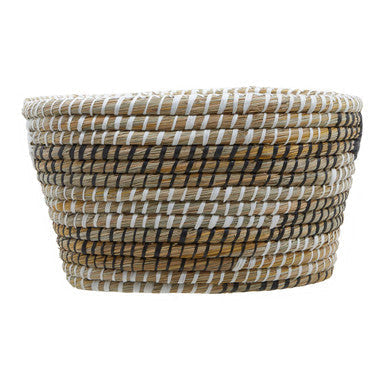 Handwoven three oval straw baskets in beige brown and white with a tight textured pattern for versatile use