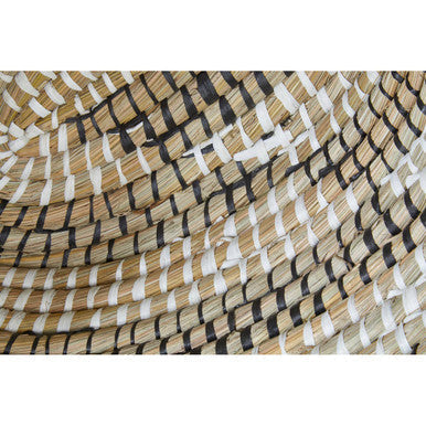 A woven straw hat with black and white stripes shown alongside three oval straw baskets from lidi set