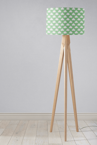 A modern tripod floor lamp with light wood finish and light green table lamp shade featuring white geometric tiles design