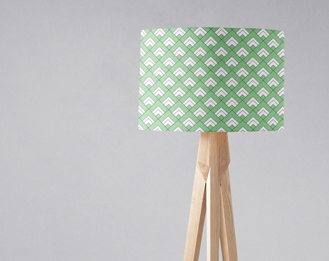 Rectangular table lamp with light green and white geometric pattern on a wood tripod base