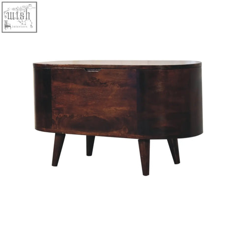 Dark brown oval wooden sideboard with tapered legs and single drawer next to light walnut rounded lid-up blanket box storage bench