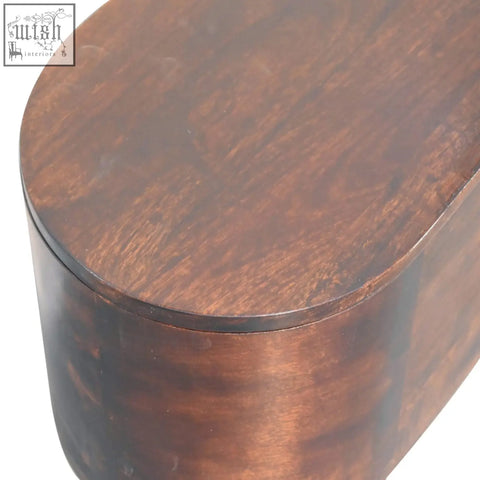 Rich dark brown wooden blanket box with smooth rounded edges and polished finish like a light walnut rounded lid-up bench