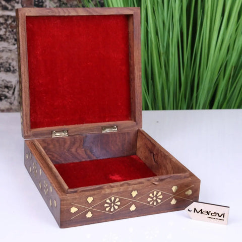 A dark lila sheesham wood trinket box with intricate brass inlay and red velvet lining by maravi