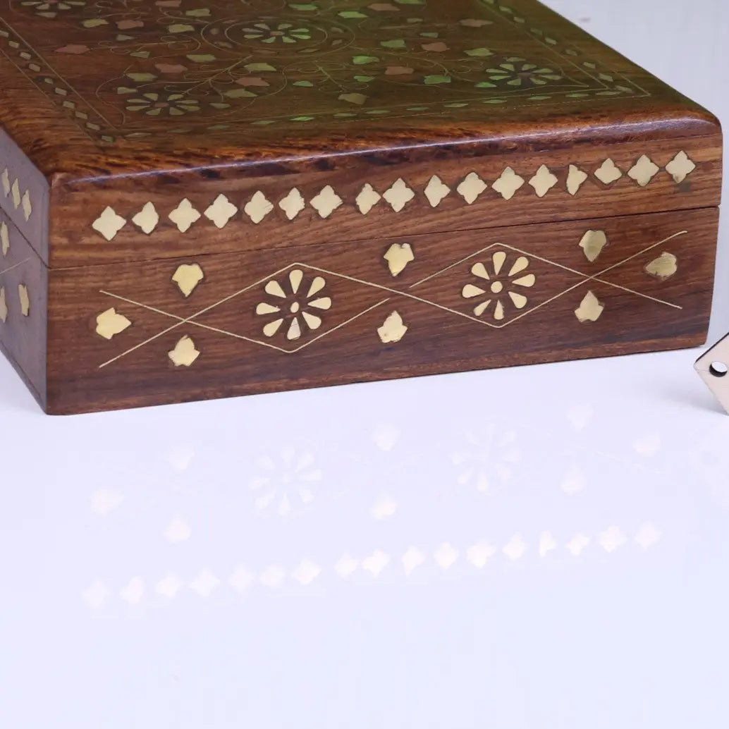 A dark brown lila sheesham wood trinket box with intricate brass inlay floral patterns for storing small items