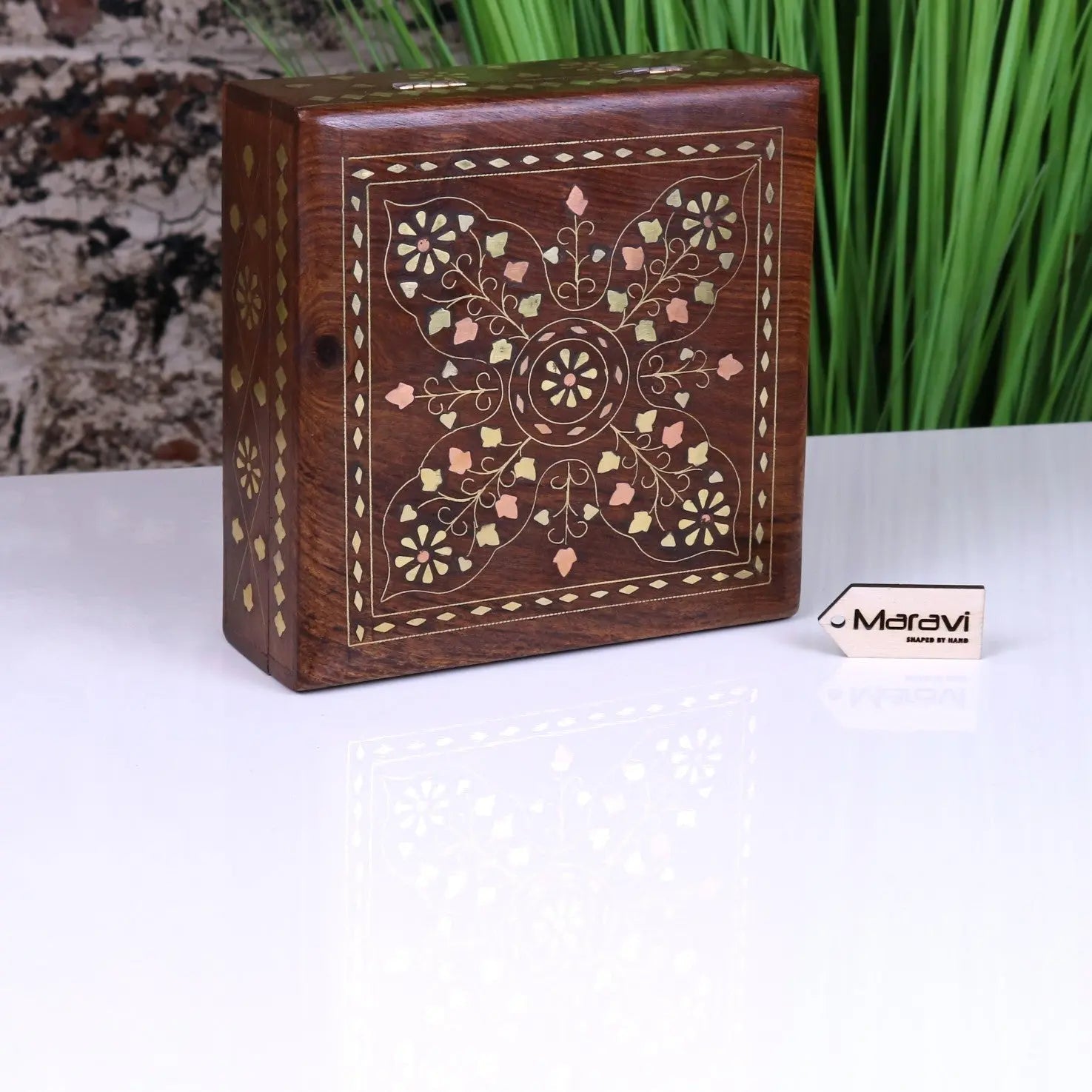 A rectangular lila sheesham wood trinket box with intricate brass inlay floral and geometric patterns in gold cream pink hues