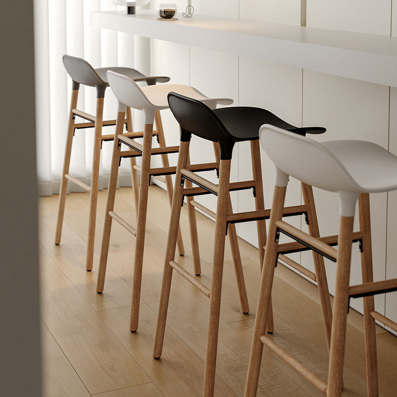 Modern lila sketchy bar stools with sleek curved black and white plastic seats on light wood legs for stylish seating