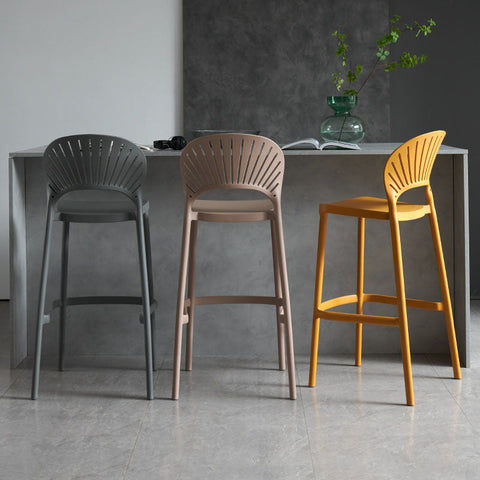 Three lilith bar stools with sleek fan-shaped backrests in gray beige and mustard yellow for modern seating