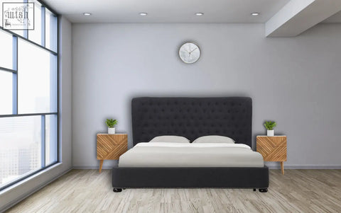 Black tufted velvet headboard bed with matching base and white bedding next to solid mango wood lille 2-drawer bedside table
