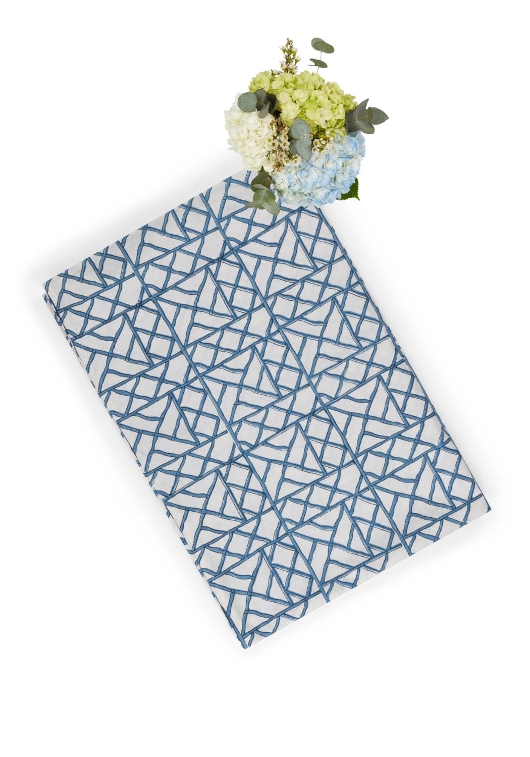 A rectangular notebook with a white cover and blue geometric lattice pattern inspired by lily’s blue bamboo breeze tablecloth