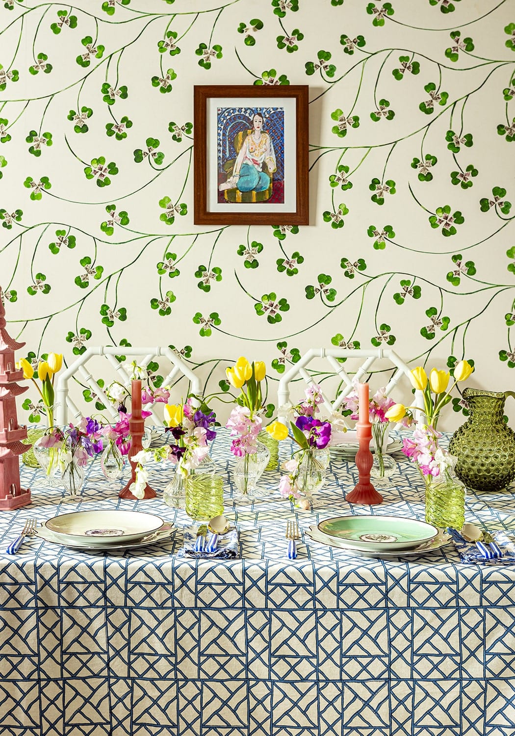 A vibrant floral arrangement with yellow tulips and purple pansies on a blue bamboo breeze tablecloth