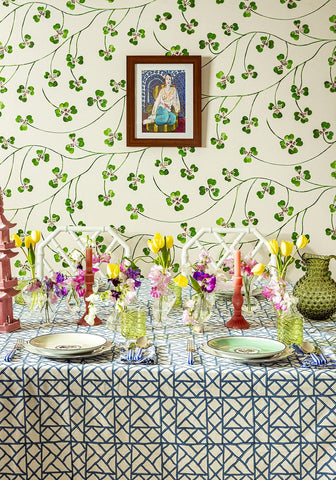 A vibrant floral arrangement with yellow tulips and purple pansies on a blue bamboo breeze tablecloth