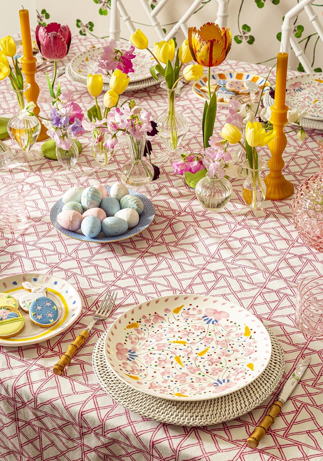 A white ceramic plate with pink and blue floral pattern on lily’s pink bamboo lattice tablecloth
