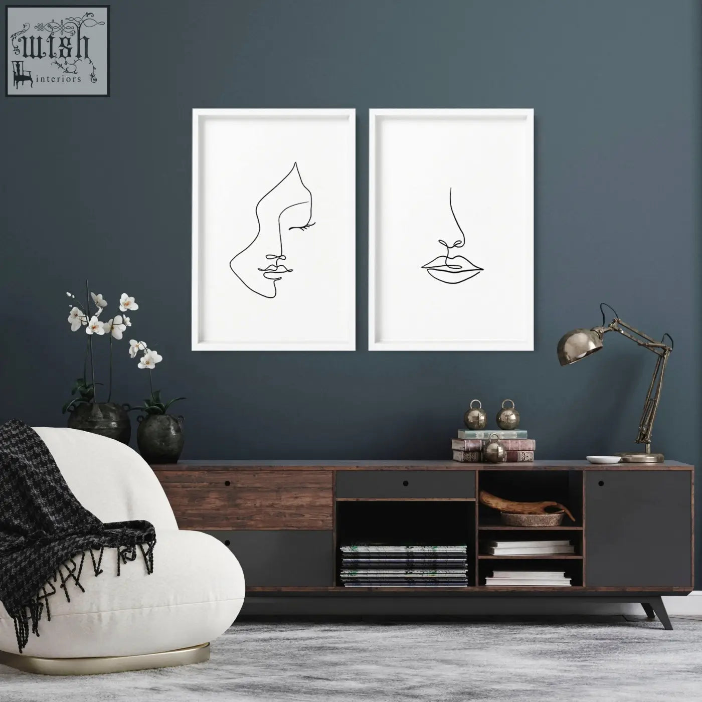 Two minimalist black line art wall art prints in white frames showing a face and lips on a dark blue living room wall