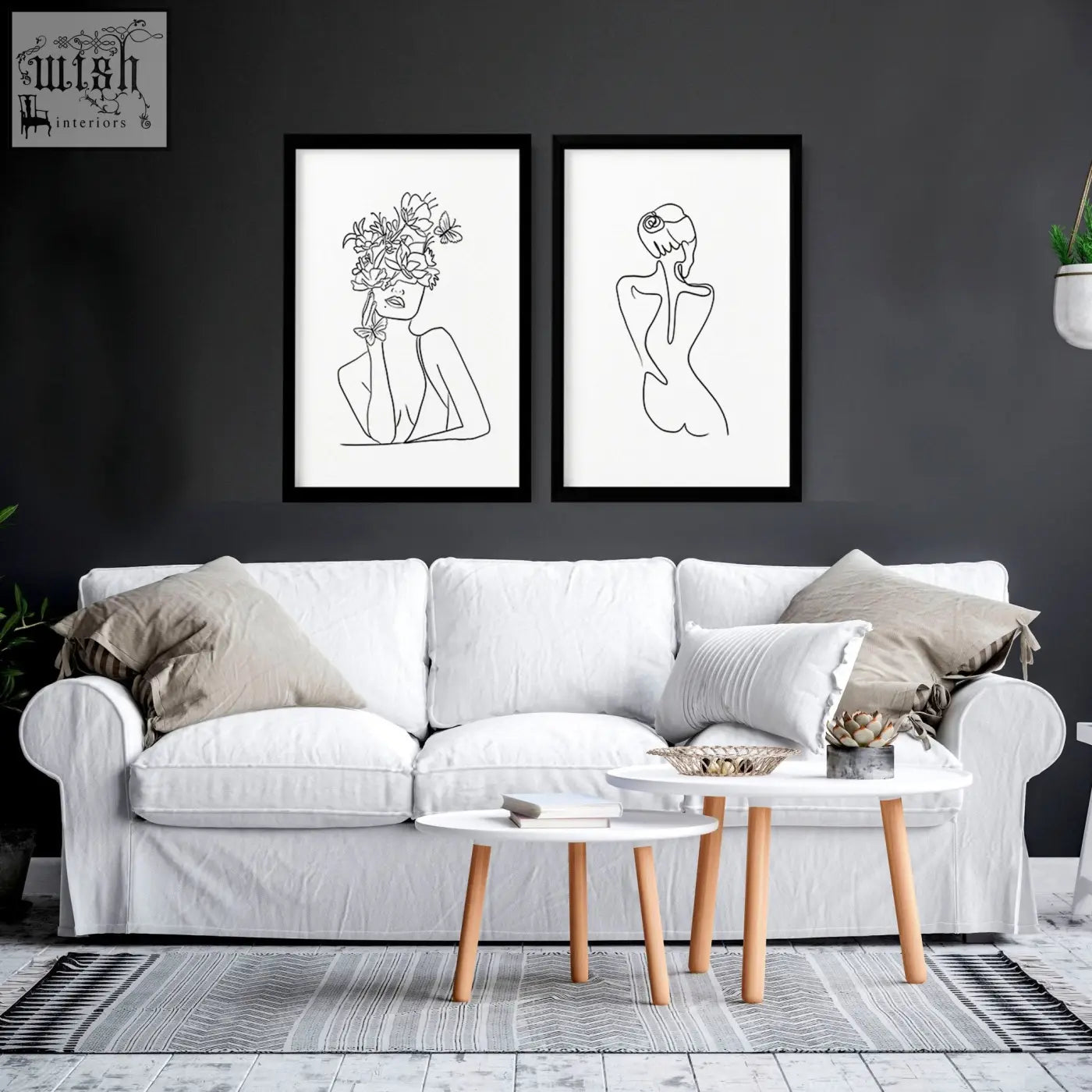 White upholstered sofa with beige and white throw pillows in living room featuring feminine line drawings art prints set of 2