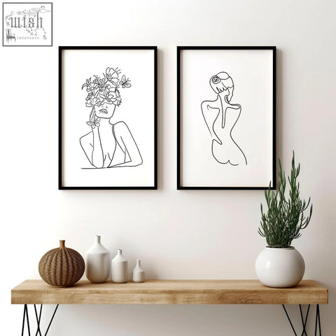 Two minimalist black-framed line drawings art prints featuring a woman with flowers and a back view for living room decor