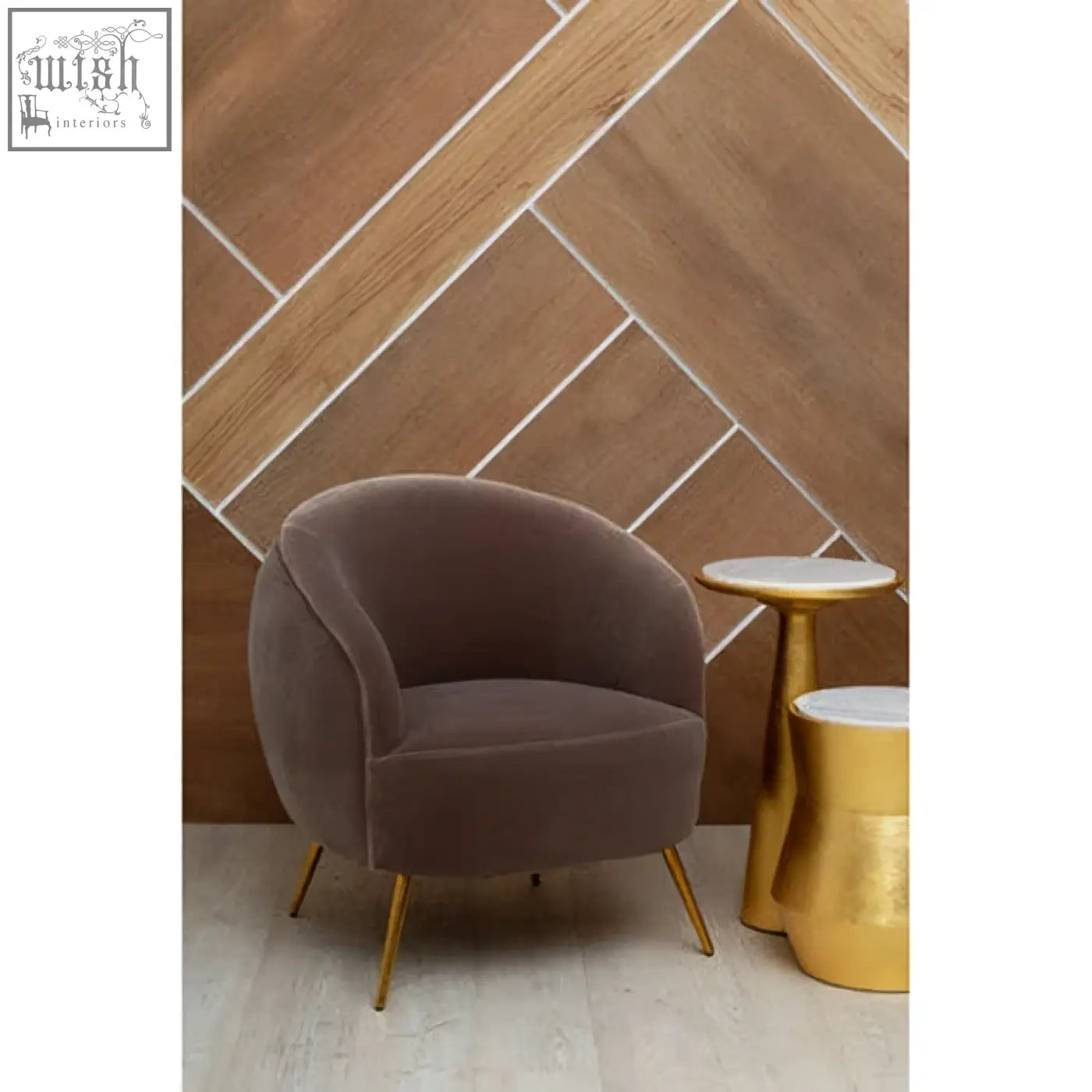 A plush taupe velvet armchair with slender gold legs paired with a lino large gold side table in a stylish setting