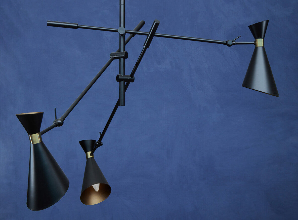 Linox 3 shade black and gold pendant features black conical shades with brass accents on a minimalist metal armature
