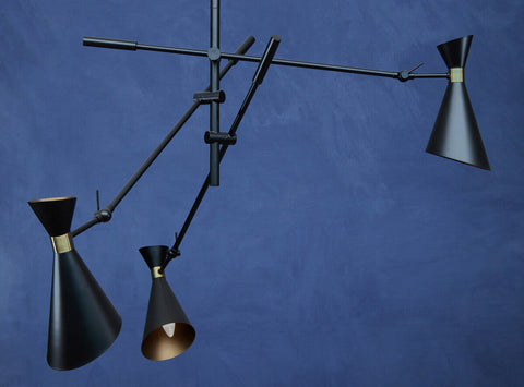 Linox 3 shade black and gold pendant features black conical shades with brass accents on a minimalist metal armature