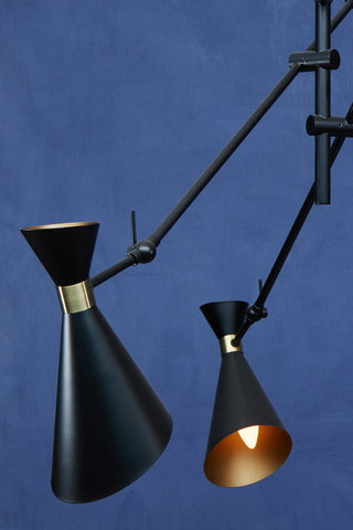 Black conical pendant lights with brass accents and adjustable arms from the linox 3 shade black and gold pendant