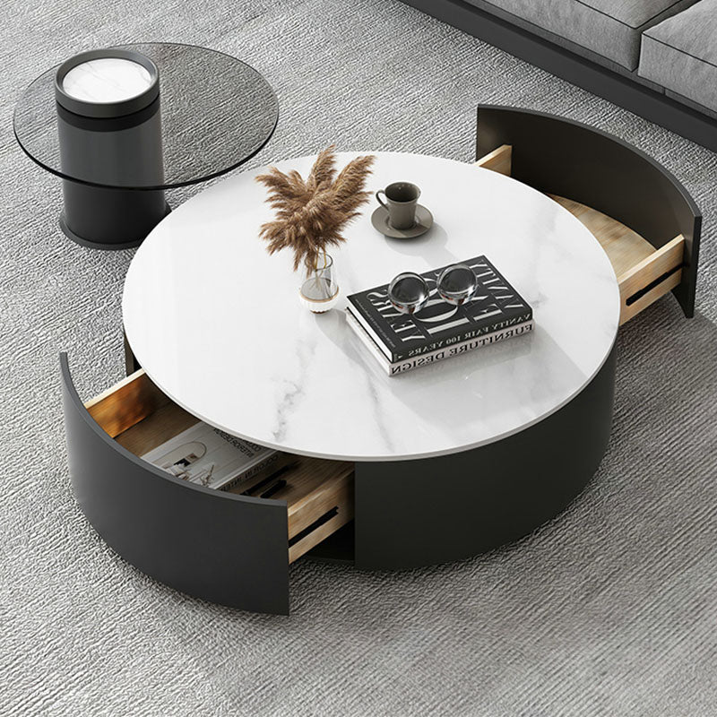 Modern round nesting coffee table set with white marble top black curved sides and light wood open drawers