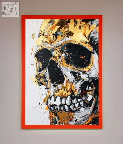 A bold liquid gold skull framed print with gold and black splashes on white background in a vibrant red frame