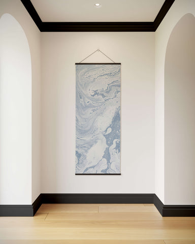 A vertical liquid marble tapestry with swirling blue and white marble pattern framed by a thin black border