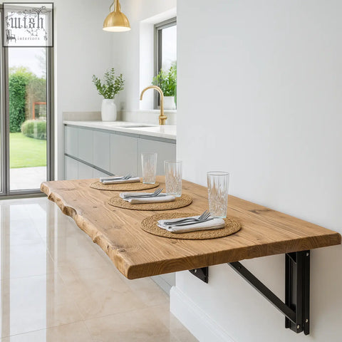 A rustic light brown live edge foldable solid wood table with black metal wall-mounted brackets for small spaces