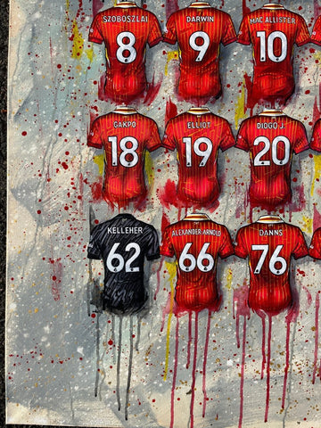 Framed print of a vibrant red and black manchester united football jersey art with player names on splattered background
