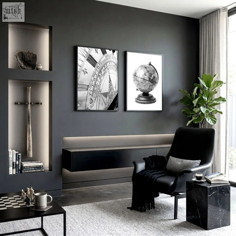 Black leather armchair with gray cushion and black fringe blanket next to living room framed vintage sundial and globe wall art set