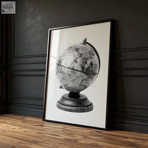Black-framed living room wall art featuring a monochrome antique globe illustration with detailed cartography and wooden base
