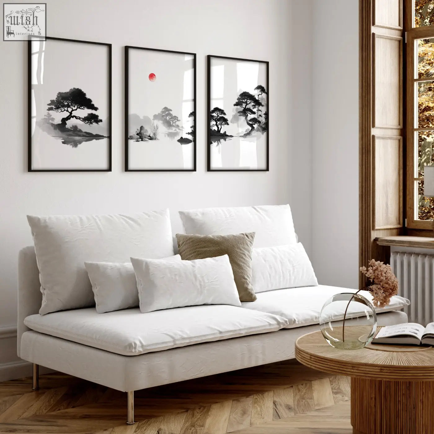 White upholstered sofa with metal legs and cushions below japandi zen landscape black white red sun living room picture set of 3