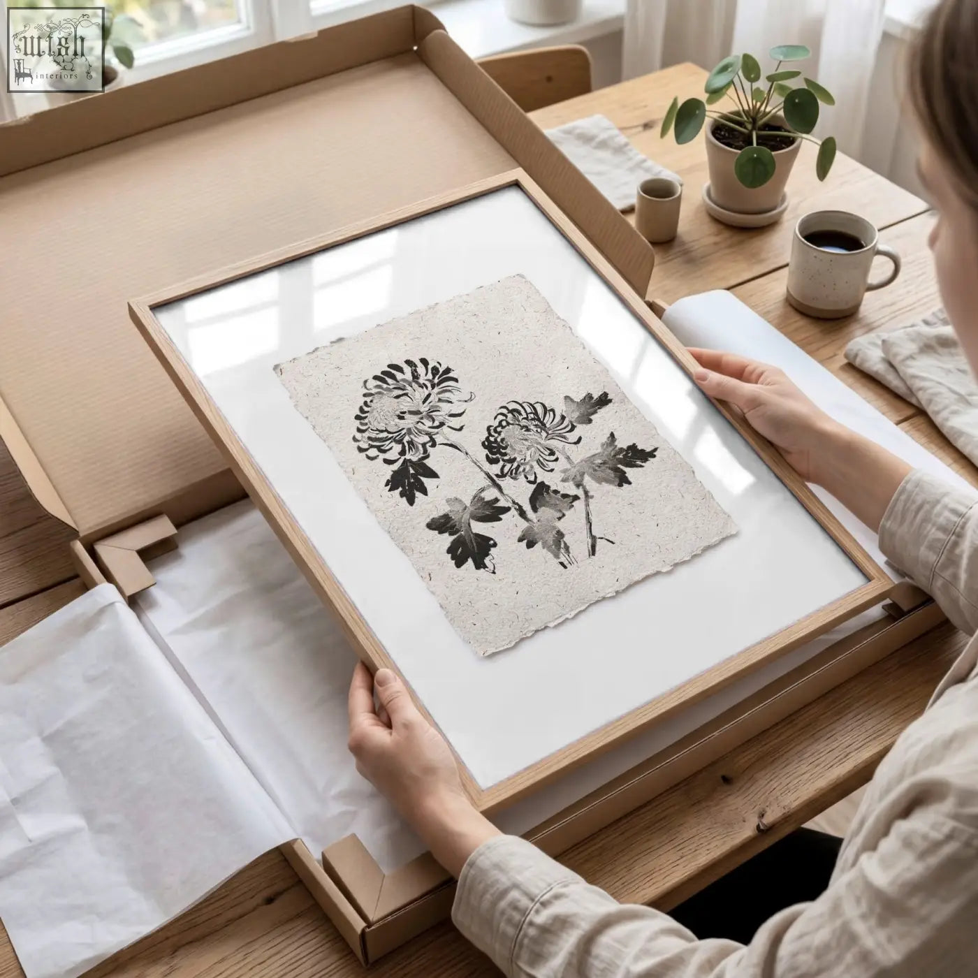 A minimalist wooden frame with a black ink botanical chrysanthemum print on textured paper for living room prints