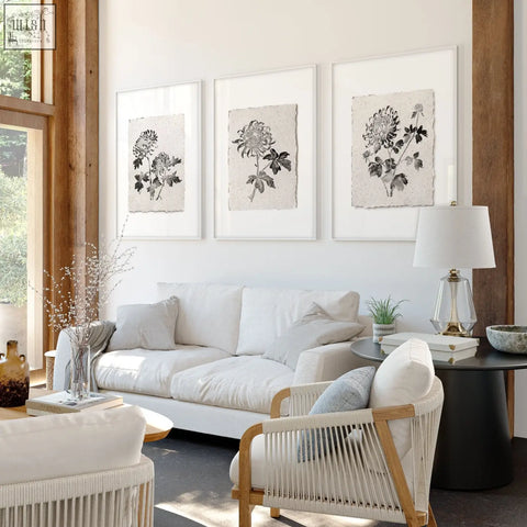 White woven wicker armchair with light wood frame perfect for living room with botanical chrysanthemum prints set