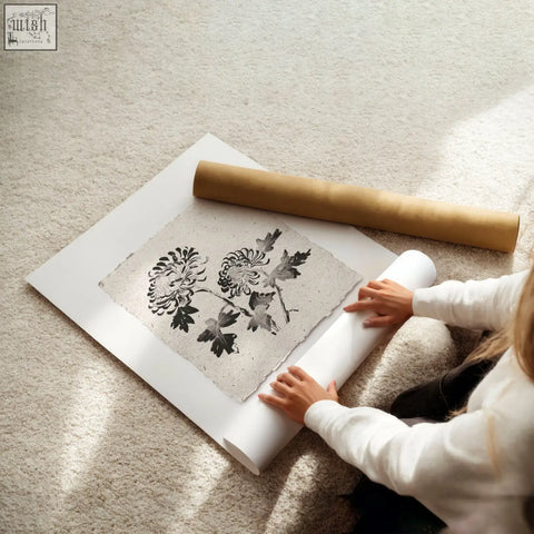 A set of 3 living room prints featuring black and white botanical chrysanthemum on textured beige paper