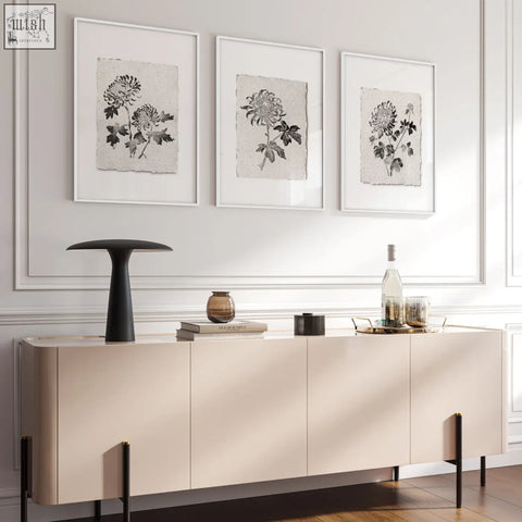 Beige modern sideboard with sleek minimalist design and black legs under living room prints botanical chrysanthemum set