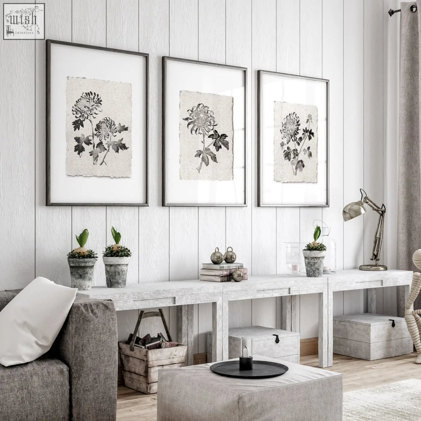 Three living room prints featuring black ink botanical chrysanthemum illustrations on beige textured paper in dark gray frames