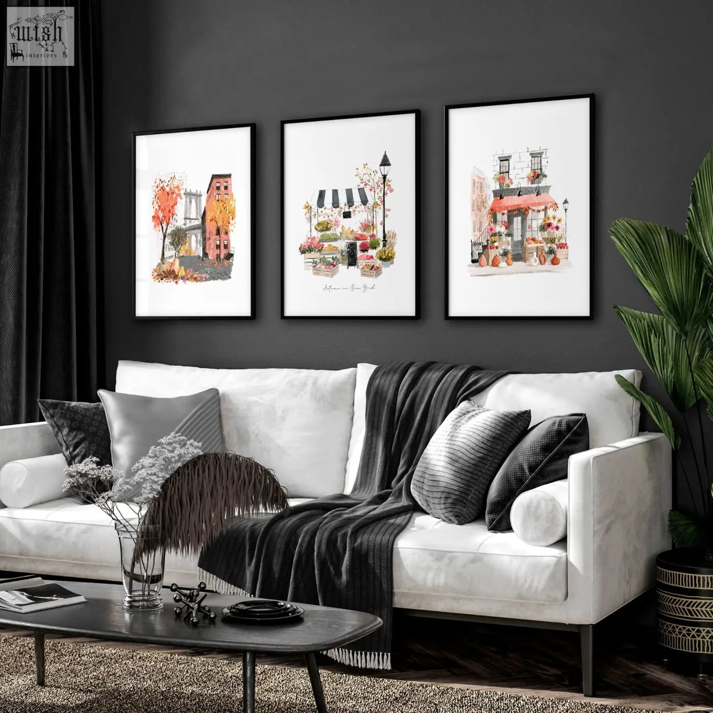 White sofa with black and gray pillows and dark gray knit blanket below autumn in new york living room wall art set