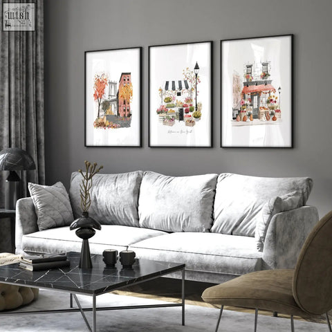 Gray velvet sofa with matching pillows and sleek black marble coffee table in living room featuring autumn in new york wall art