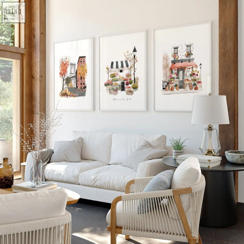White wicker armchair with light wood frame in living room setting with autumn in new york wall art set of 3