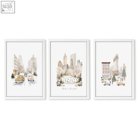Set of three white-framed watercolor living room wall art prints featuring snowy new york city winter scenes