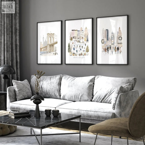 Gray velvet sofa with matching pillows and black marble coffee table below winter in new york beige living room wall art set of 3