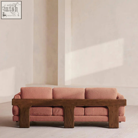 Liwanag three seater sofa with plush dusty rose boucle fabric and sturdy dark wood frame for cozy seating