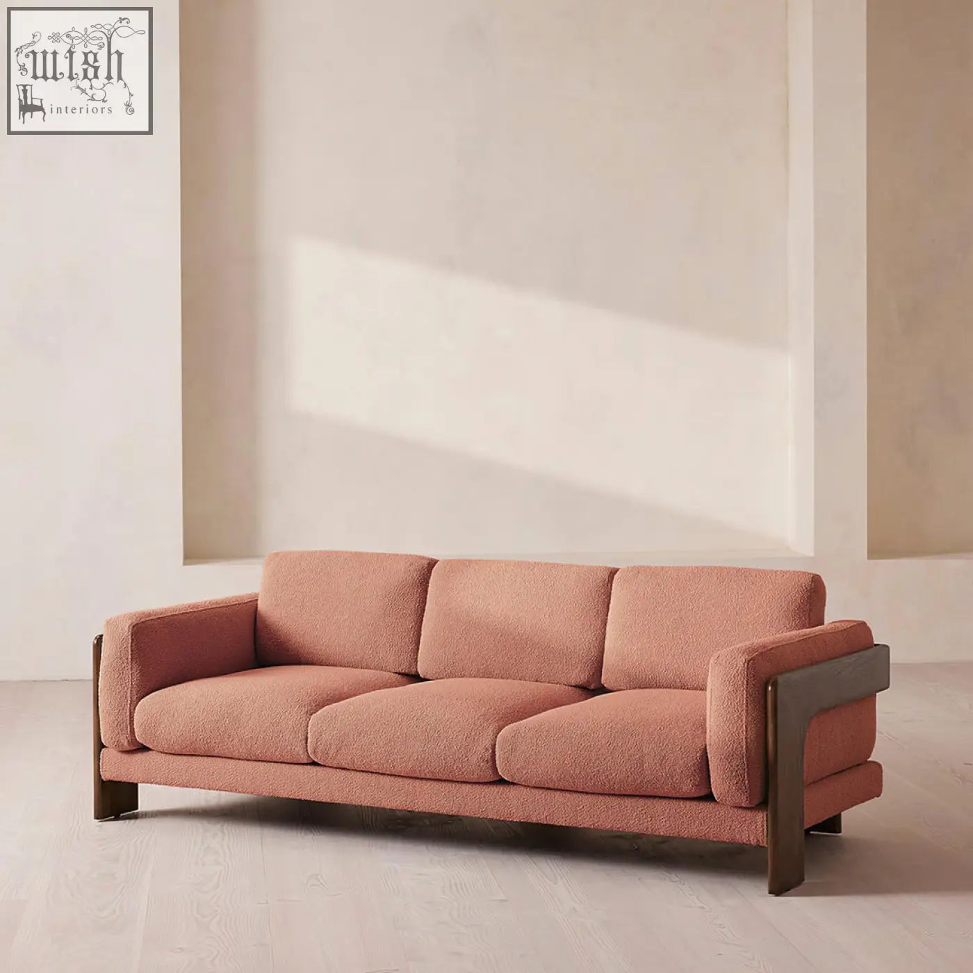 Liwanag three seater sofa in soft terracotta boucle fabric with sleek dark wood frame accents for modern living rooms