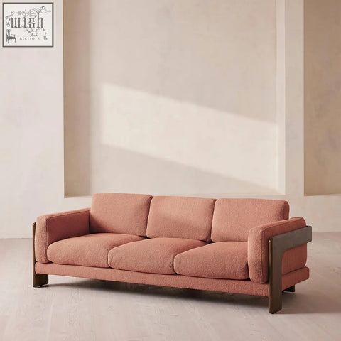 Liwanag three seater sofa in soft terracotta boucle fabric with sleek dark wood frame accents for modern living rooms