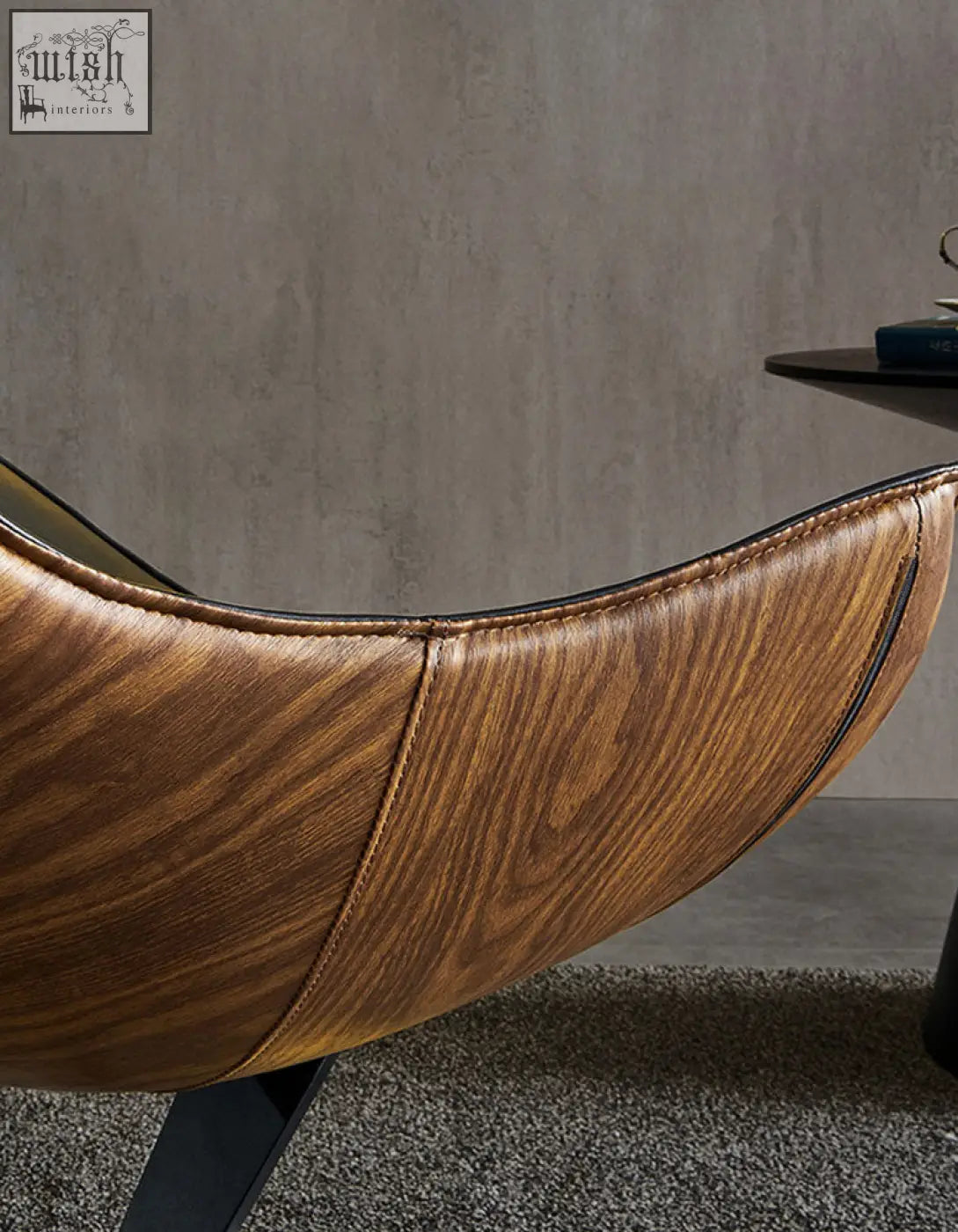 Brown faux leather lobster lounge chair with wood grain pattern and black stitching along the edges