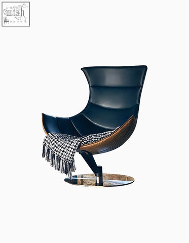 Elegant navy blue leather lobster lounge chair with sleek wooden base chrome pedestal and black and white throw blanket