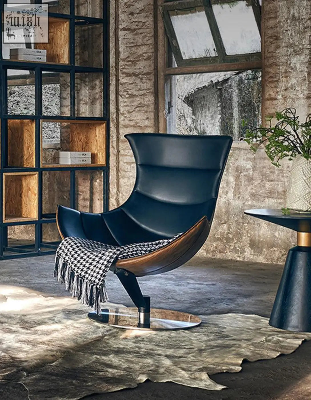 Black leather lobster lounge chair with wooden base and chrome pedestal perfect for stylish lounging