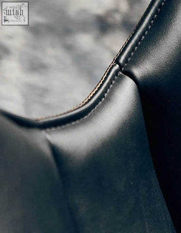 Black leather lobster lounge chair with precise contrasting stitching along the seam for stylish comfort